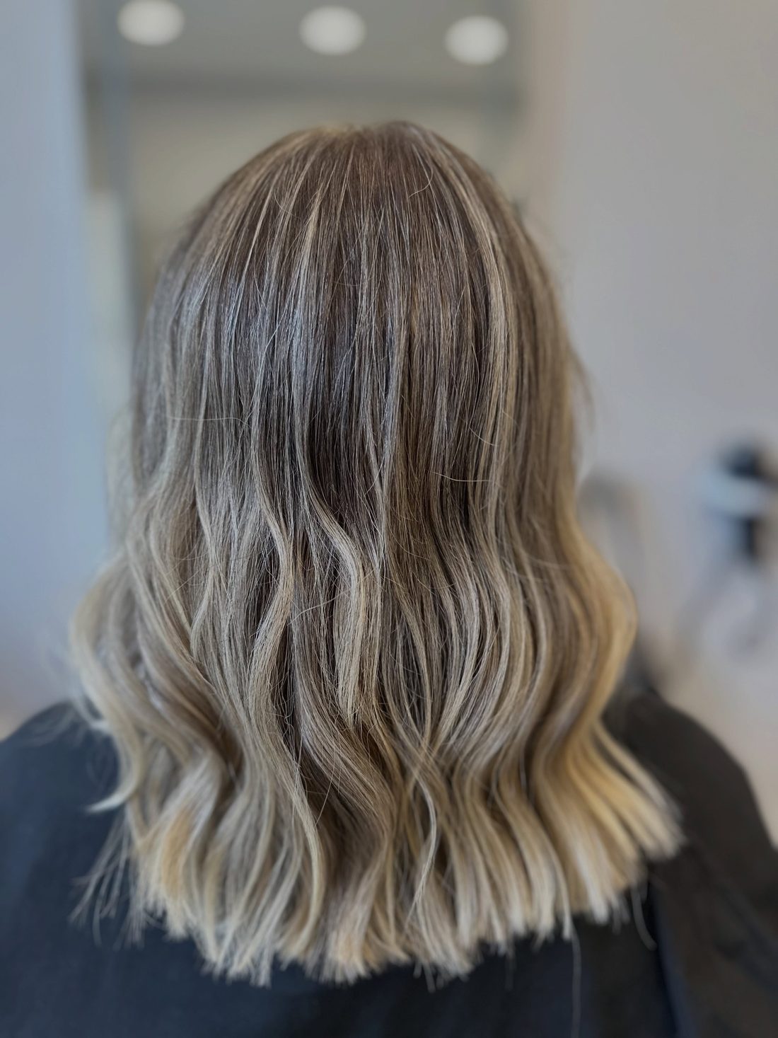Blonder Balayage-Verlauf mit weichen Wellen, fotografiert nach dem Termin im Salon